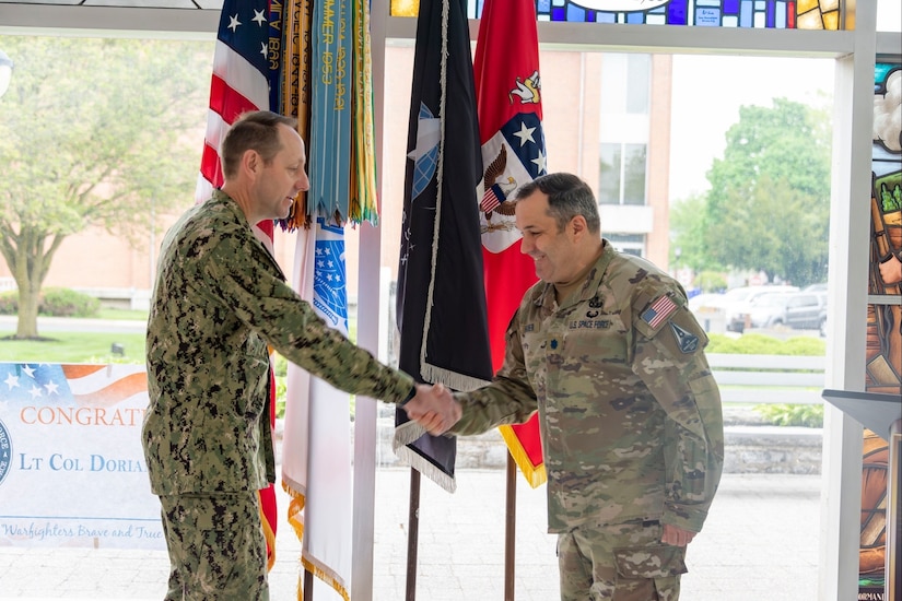 U.S. Navy Capt. Michael Hritz (left) shakes hands with then Lt. Col. Dorian C. Hatcher (right) during Hatcher's transfer ceremony to U.S. Space Force at the U.S. Army War College on Carlisle Barracks, Pennsylvania, April 27, 2023.