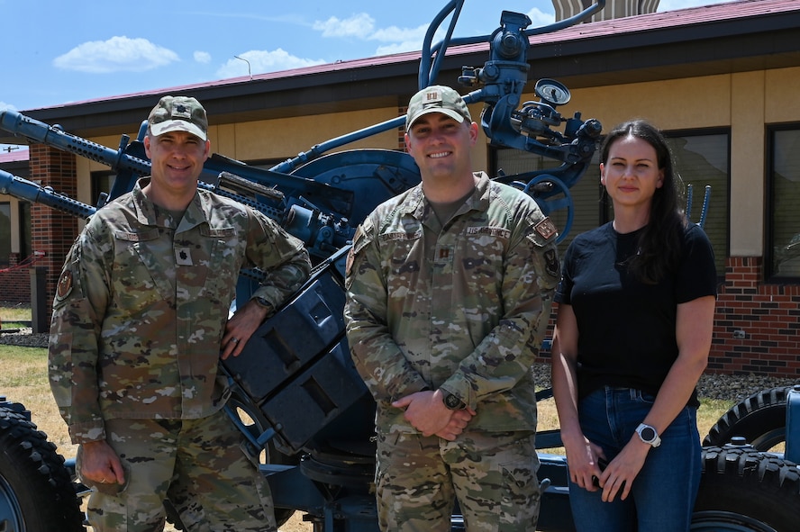 Members of the Dyess Operational Support Team pose in front of the 317th Airlift Wing combined building at Dyess Air Force Base, Texas, Aug. 24, 2023. OST typically consists of four members: a physical therapist, strength and conditioning coach, team specialist and a mental health professional. (U.S. Air Force photo by Senior Airman Sophia Robello)