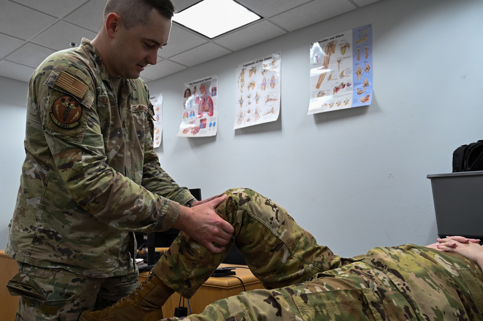 Capt. Micah Easterling, 7th Medical Group physical therapist and Dyess Operational Support Team member, completes a wellness check on Senior Airman Bryce Nelson, 39th Airlift Squadron loadmaster, at Dyess Air Force Base, Texas, Aug. 24, 2023. OST embeds into units for three to six months and aims to take care of and build healthier Airmen, reducing the number of physical and mental wellness issues that may prevent them from deploying. (U.S. Air Force photo by Senior Airman Sophia Robello)