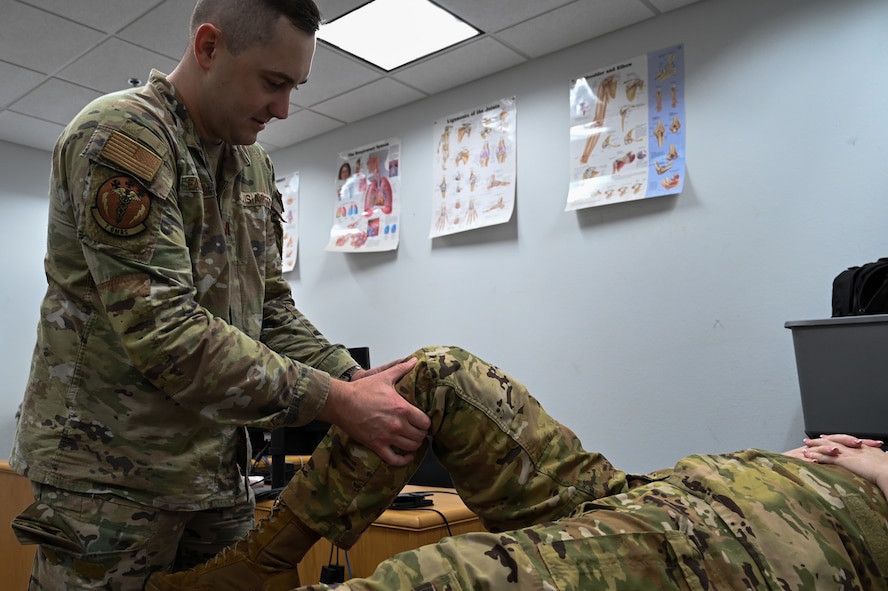 Capt. Micah Easterling, 7th Medical Group physical therapist and Dyess Operational Support Team member, completes a wellness check on Senior Airman Bryce Nelson, 39th Airlift Squadron loadmaster, at Dyess Air Force Base, Texas, Aug. 24, 2023. OST embeds into units for three to six months and aims to take care of and build healthier Airmen, reducing the number of physical and mental wellness issues that may prevent them from deploying. (U.S. Air Force photo by Senior Airman Sophia Robello)