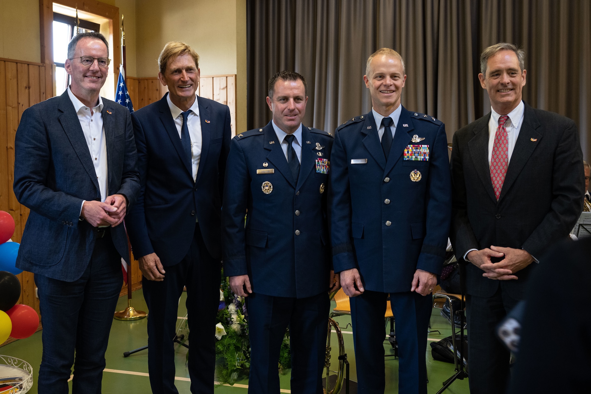 U.S. Air Force leadership stand with distinguished members of the community at an event celebrating the Host Nation Council at the Spangdahlem Community Center.