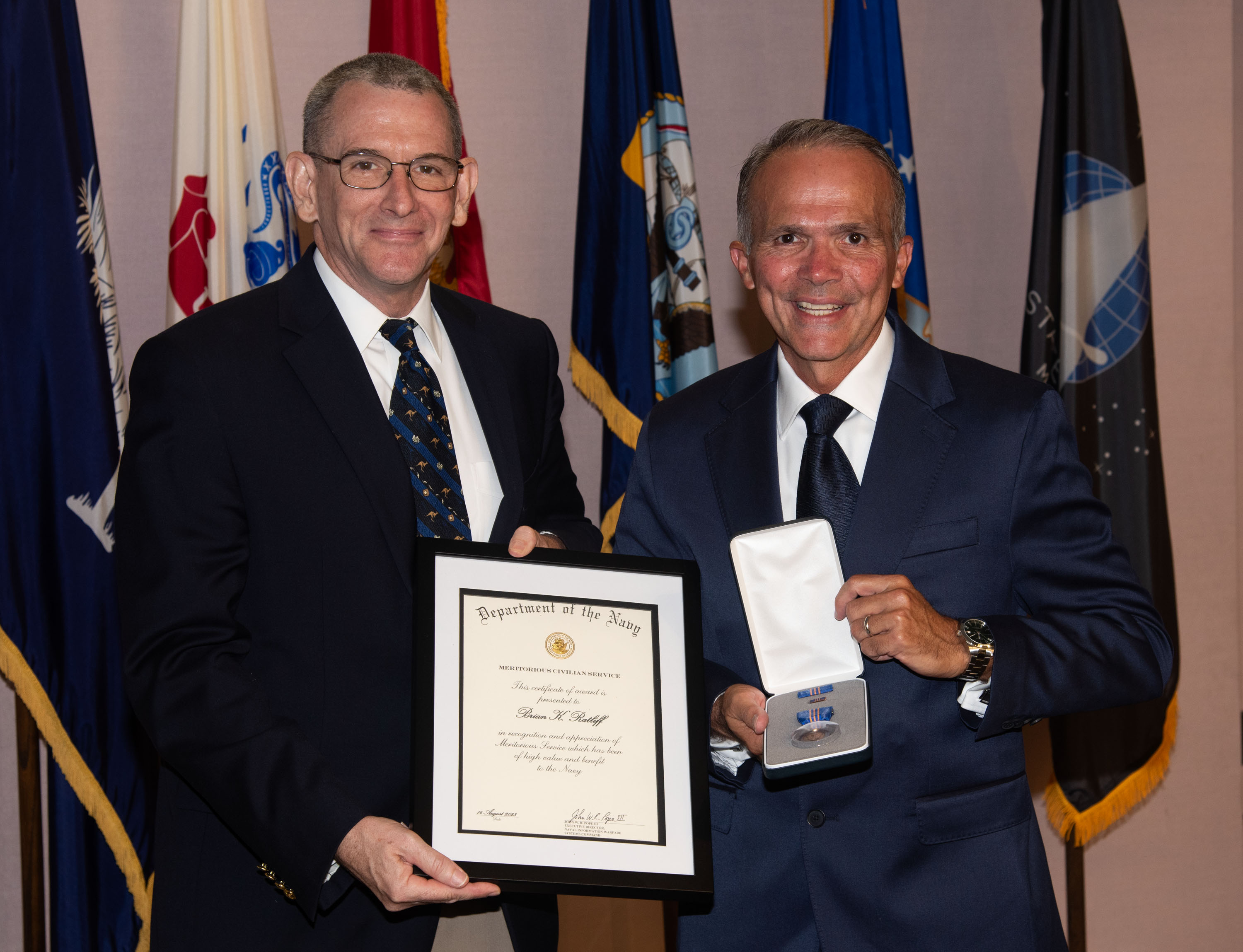 Naval Information Warfare Center (NIWC) Atlantic’s Executive Director Peter Reddy presents an award to a NIWC Atlantic employees during Naval Information Warfare Systems Command (NAVWAR) Fiscal Year 2023 3rd Quarter Awards Ceremony.