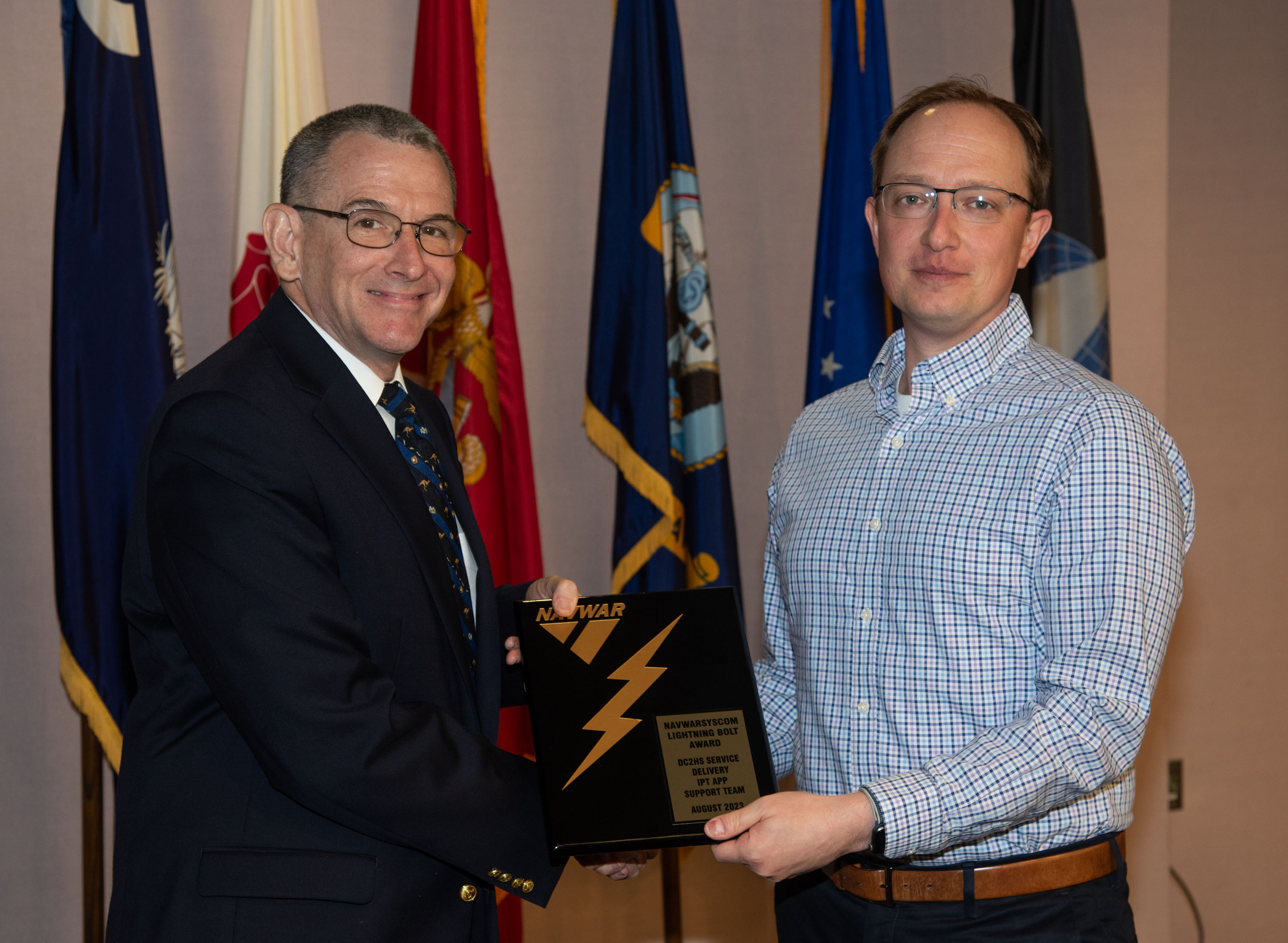 Naval Information Warfare Center (NIWC) Atlantic’s Executive Director Peter Reddy presents an award to a NIWC Atlantic employees during Naval Information Warfare Systems Command (NAVWAR) Fiscal Year 2023 3rd Quarter Awards Ceremony.