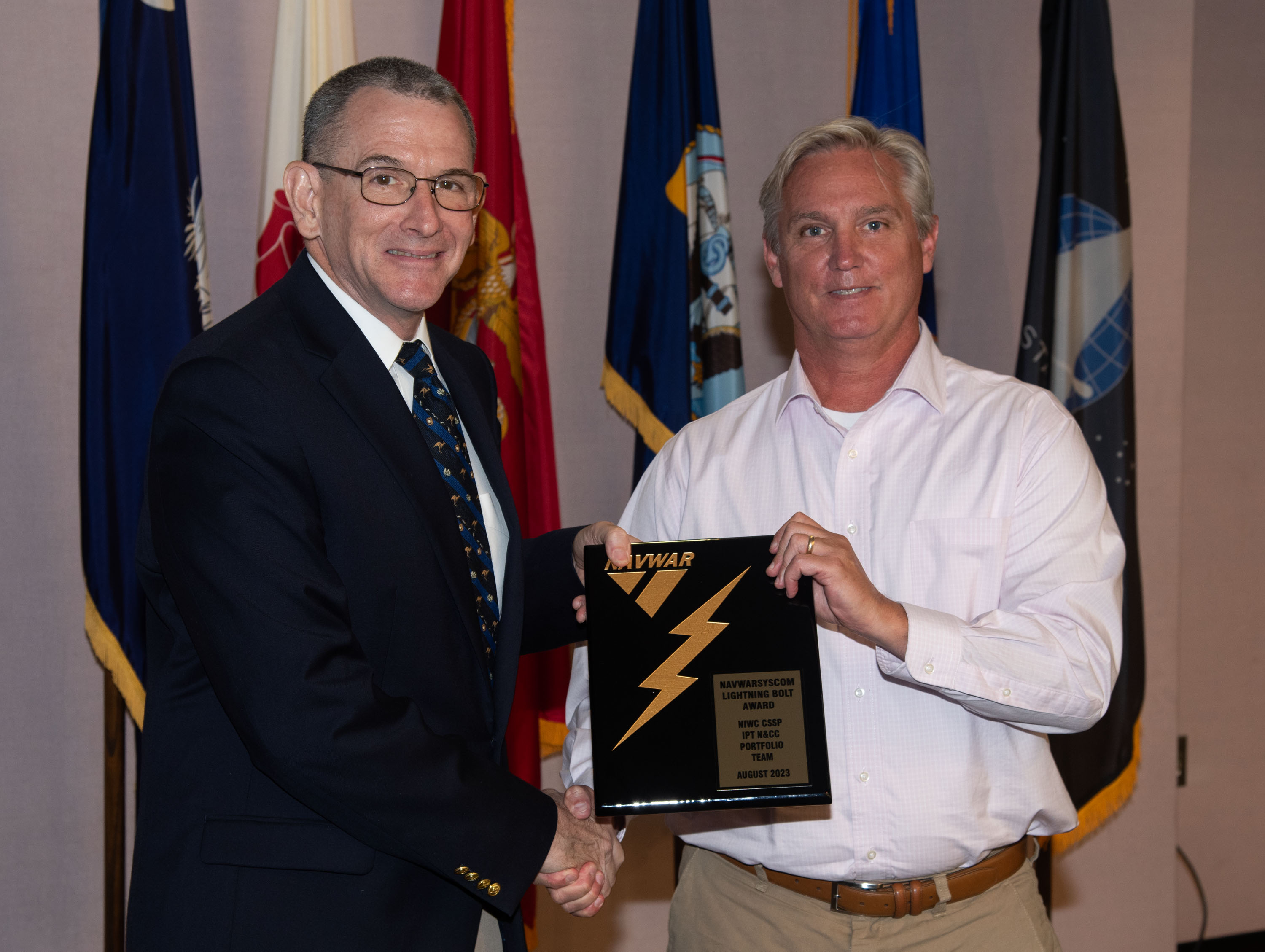 Naval Information Warfare Center (NIWC) Atlantic’s Executive Director Peter Reddy presents an award to a NIWC Atlantic employees during Naval Information Warfare Systems Command (NAVWAR) Fiscal Year 2023 3rd Quarter Awards Ceremony.
