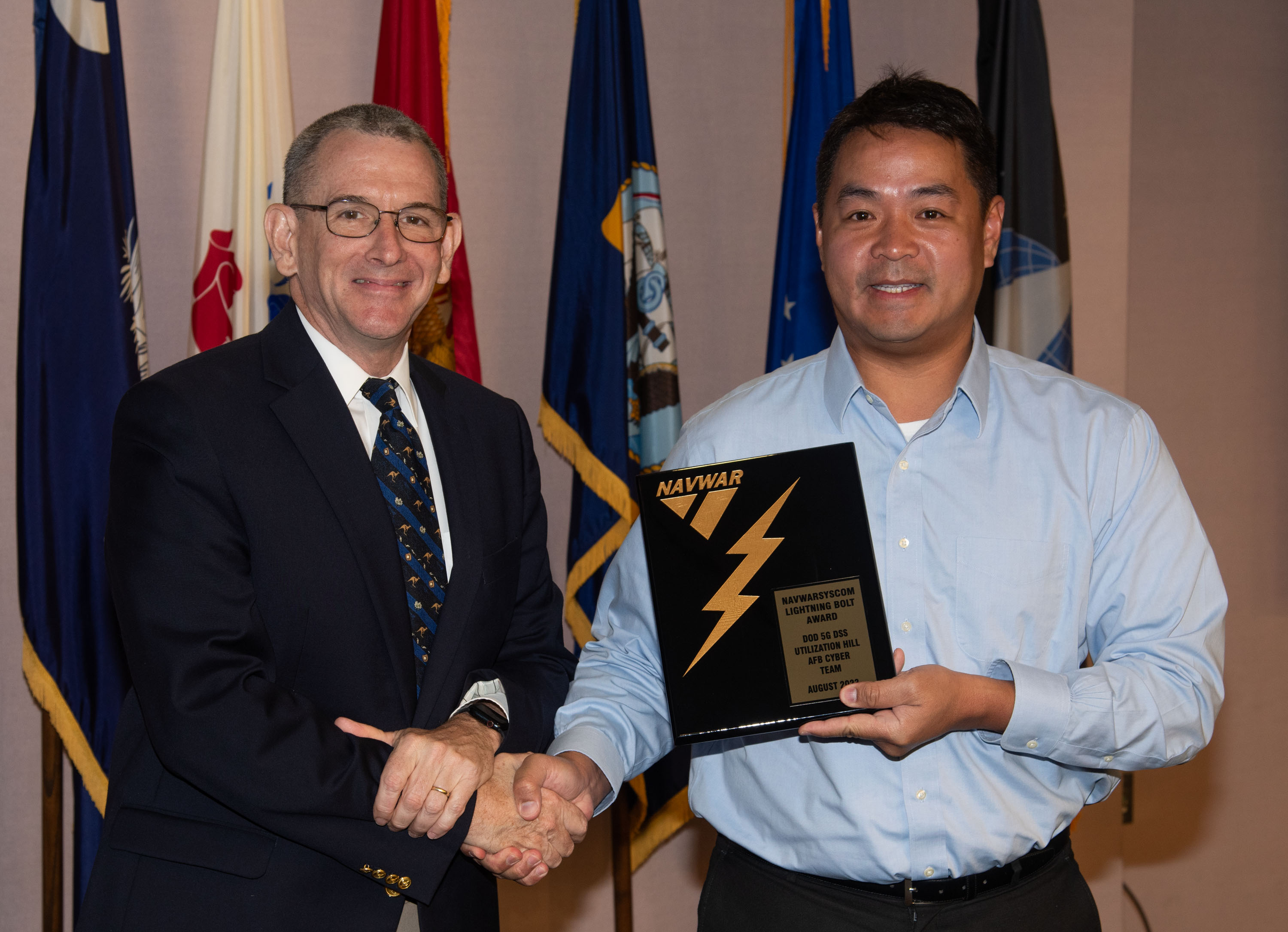 Naval Information Warfare Center (NIWC) Atlantic’s Executive Director Peter Reddy presents an award to a NIWC Atlantic employees during Naval Information Warfare Systems Command (NAVWAR) Fiscal Year 2023 3rd Quarter Awards Ceremony.
