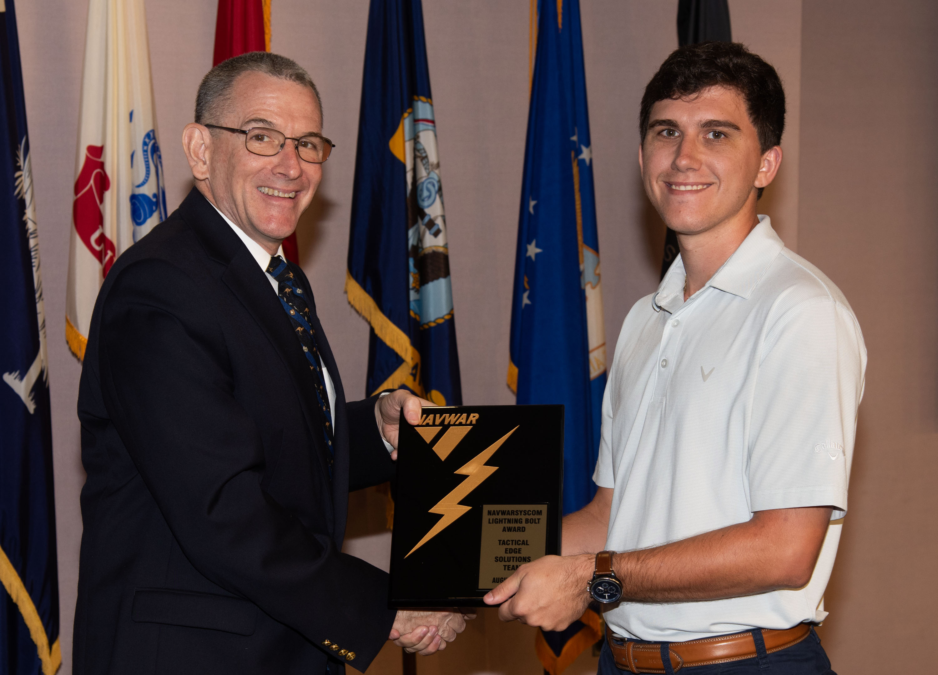 Naval Information Warfare Center (NIWC) Atlantic’s Executive Director Peter Reddy presents an award to a NIWC Atlantic employees during Naval Information Warfare Systems Command (NAVWAR) Fiscal Year 2023 3rd Quarter Awards Ceremony.