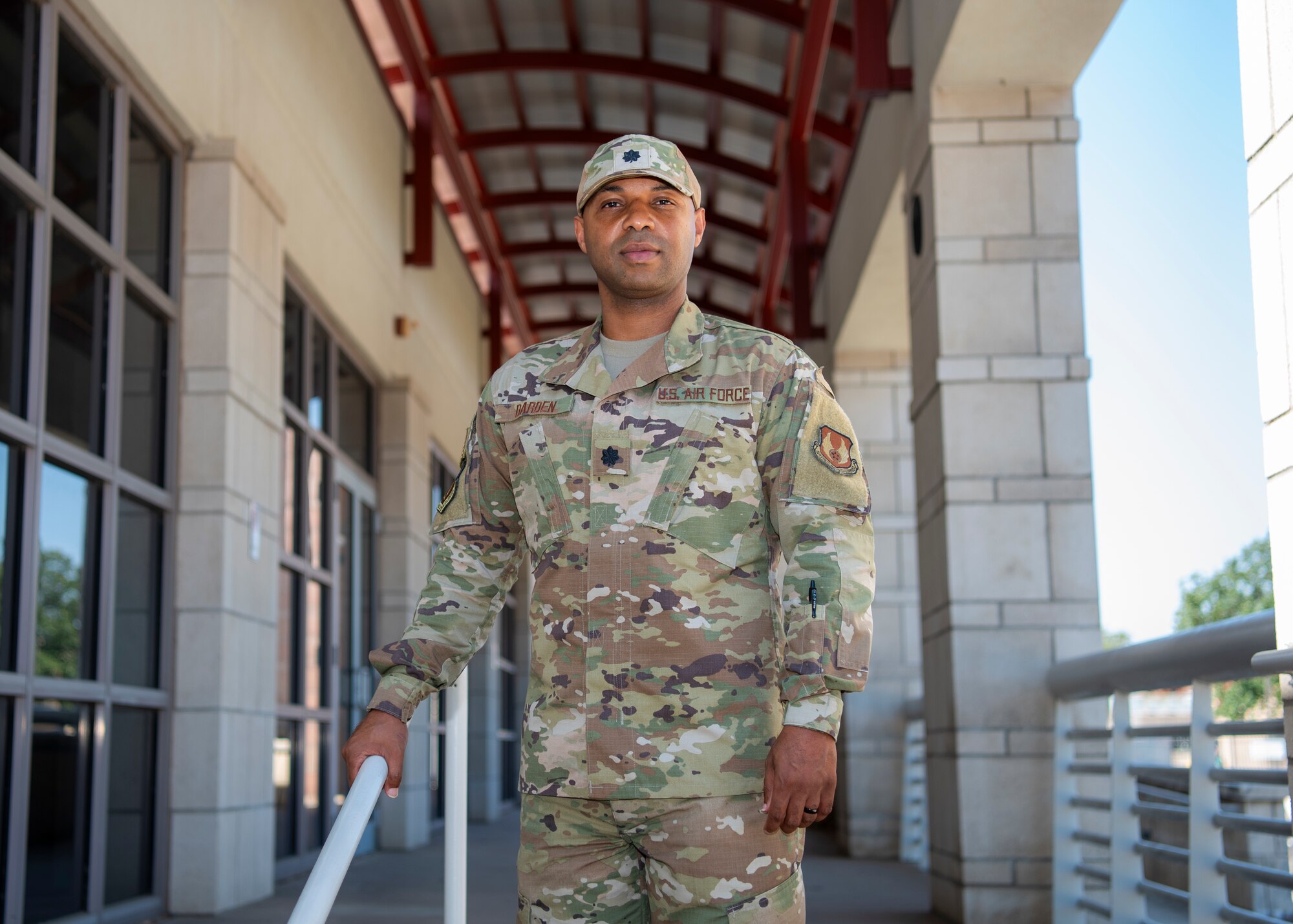 Photo of Darden in his Air Force utility uniform outside of the building