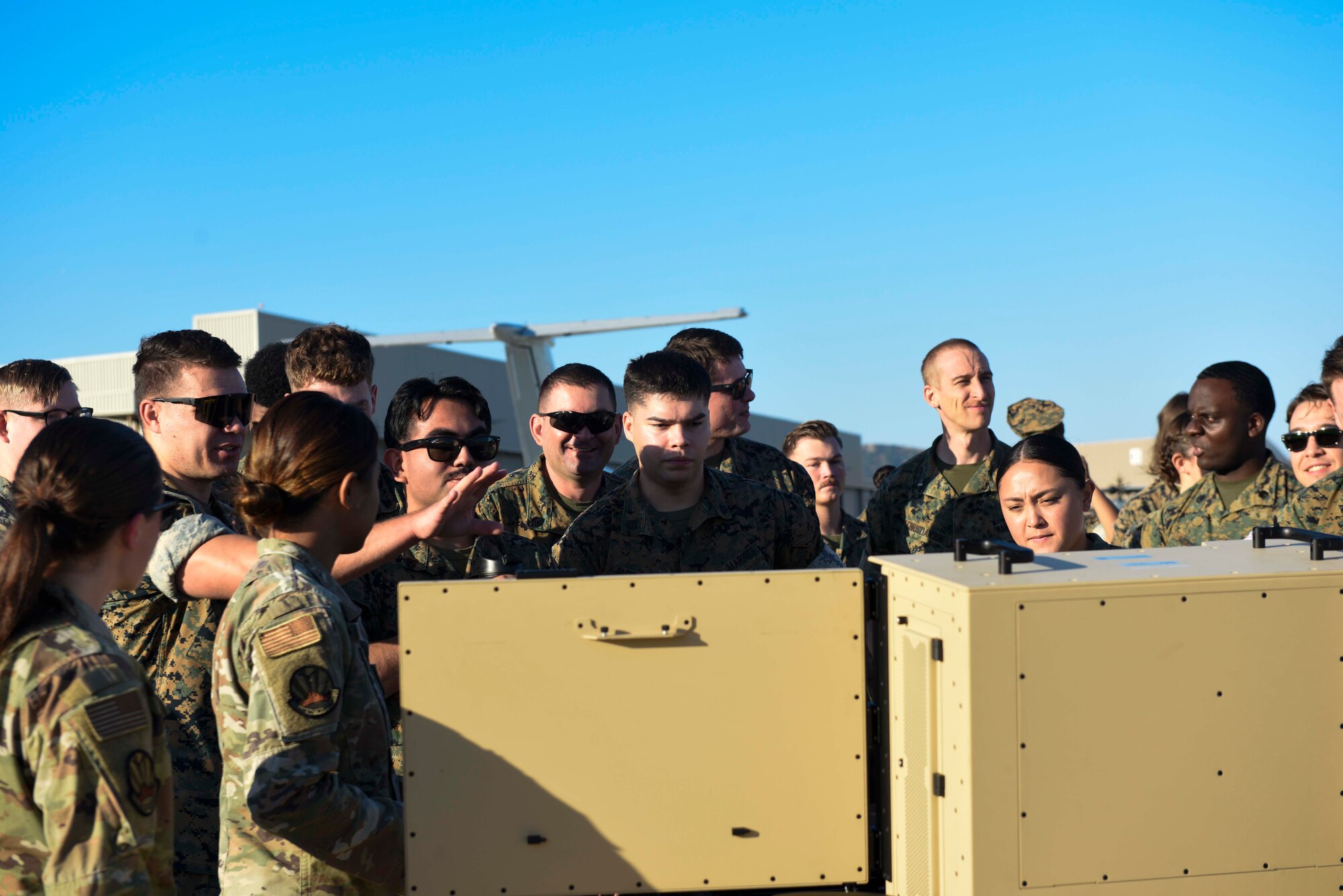 A group of Marines Look at the portable aircraft control station and are educating about it U.S. Airmen.
