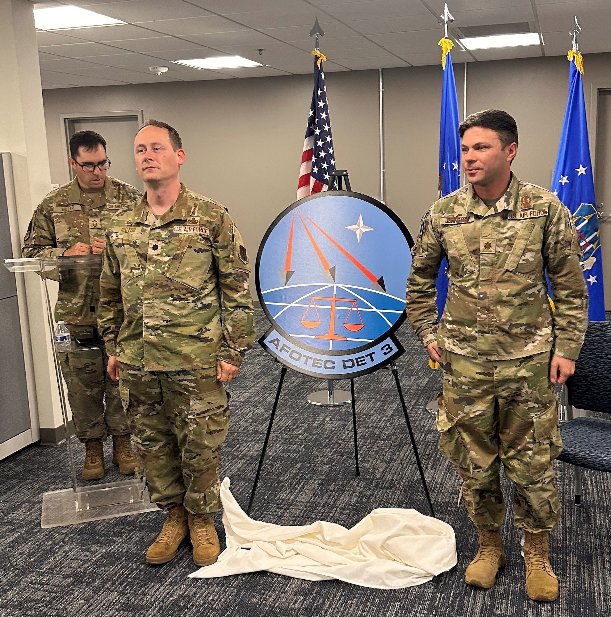 Lt. Col. Adam Rector, left, Commander, AFOTEC Detachment 3, joins Maj. Kevin Johnston, chief, Operating Location Vandenberg SFB, during the stand-up ceremony Aug. 21, 2023. Also pictured is Senior Master Sgt. Isaiah Miller, AFOTEC Detachment 3 Senior Enlisted Leader.