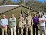 People standing in front of a tent.