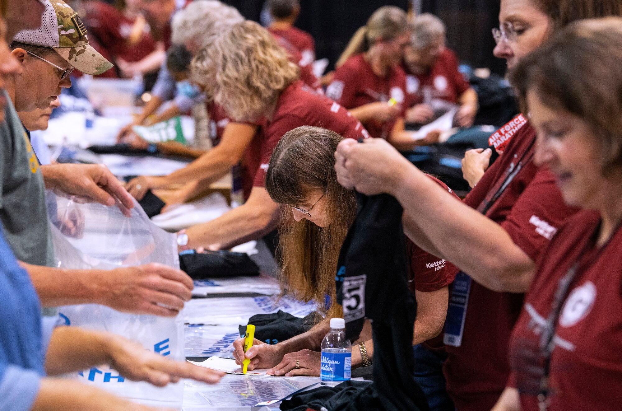 Volunteers hand race participants their packets.