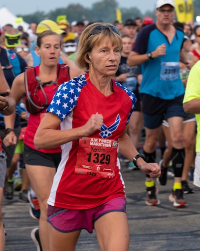 Runner in American red what and blue style shirt.