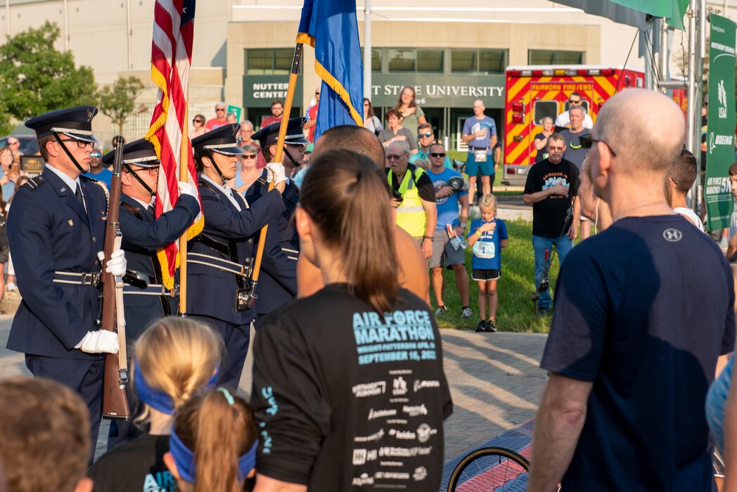 Honor Guard members present the flags in front of Air Force Marathon event attendees