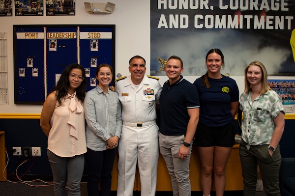 BILLINGS, Mont. (Aug. 11, 2023) Rear Adm. Matthew Case, commander, Naval Medical Forces Atlantic, poses with future Sailors during a visit to Navy Recruiting Station Billings.