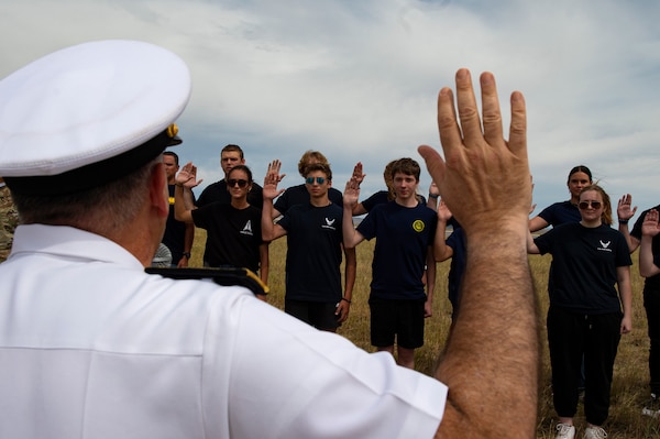 BILLINGS, Mont. (Aug. 12, 2023) Rear Adm. Matthew Case, commander, Naval Medical Forces Atlantic, swears in a group of future Sailors, Airmen, and Guardians during the 2023 Yellowstone International Air Show at Billings-Logan International Airport.