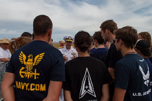 BILLINGS, Mont. (Aug. 12, 2023) Rear Adm. Matthew Case, commander, Naval Medical Forces Atlantic, speaks with a group of future Sailors, Airmen, and Guardians during the 2023 Yellowstone International Air Show at Billings-Logan International Airport.