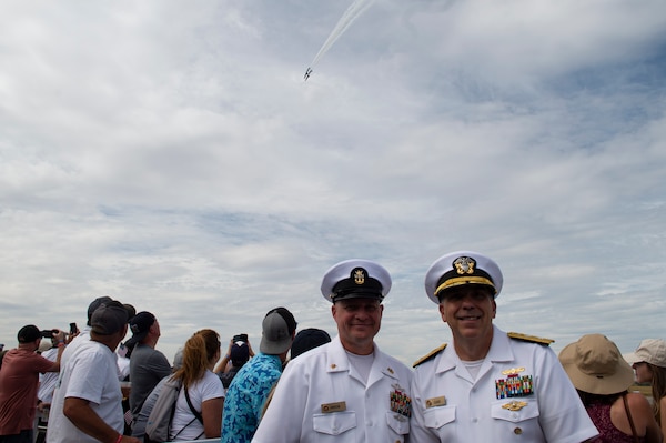 Rear Adm. Matthew Case, commander, Naval Medical Forces Atlantic (NMFL), and NMFL Command Master Chief Zachary Pryor, a native of Glendive, Mont., pose for a photo during the 2023 Yellowstone International Air Show at Billings-Logan International Airport.