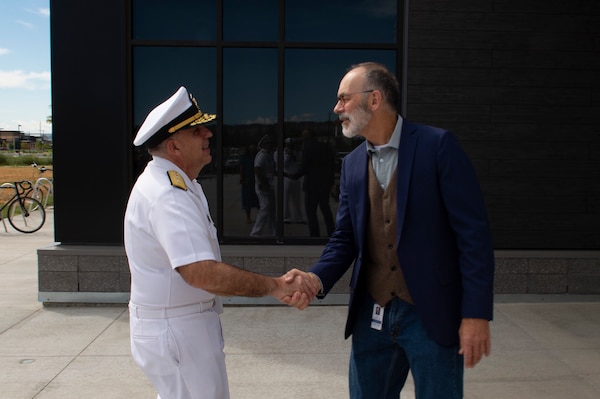 BILLINGS, Mont. (Aug. 10, 2023) Rear Adm. Matthew Case, commander, Naval Medical Forces Atlantic, shakes hands with Dr. John Moore, the director of the master of medical sciences program at Rocky Vista University.