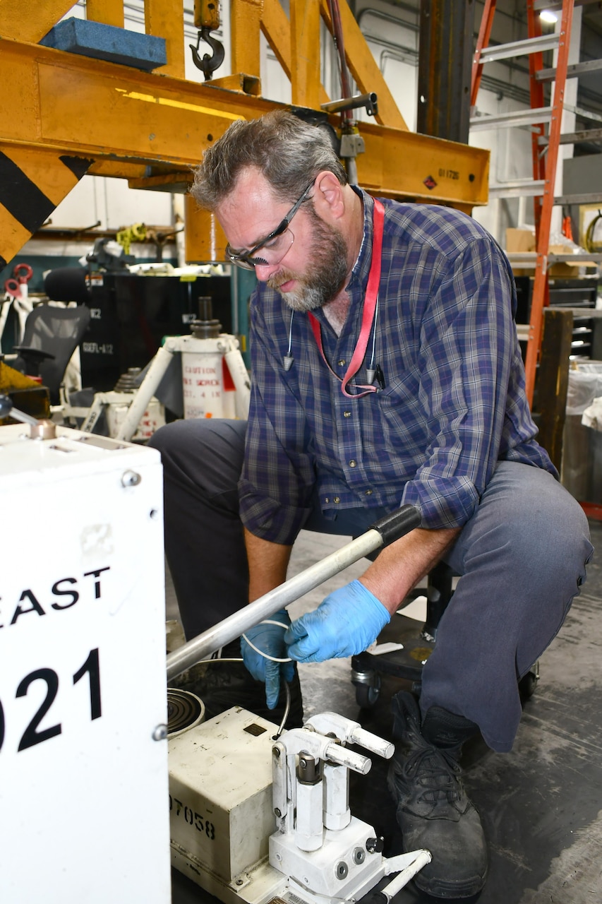 Michael Lyon, equipment and facility services specialist at Fleet Readiness Center East (FRCE), schedules ground support equipment for preventive maintenance in the Ground Support Branch. Ground support mechanics at FRCE are responsible for maintaining more than 2,000 pieces of support equipment used to support aircraft maintenance, repair and overhaul operations at the depot. These items can include aircraft work stands, electric carts, diesel forklifts, and other transportation and test equipment.