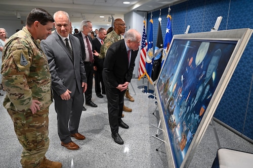 Secretary of the Air Force Frank Kendall, right, examines a painting by artist Warren Neary, second from left, after an unveiling ceremony at the Pentagon, Arlington, Va., Aug. 29, 2023. The painting celebrates the 75th anniversary of the U.S. Air Force. (U.S. Air Force photo by Eric Dietrich)