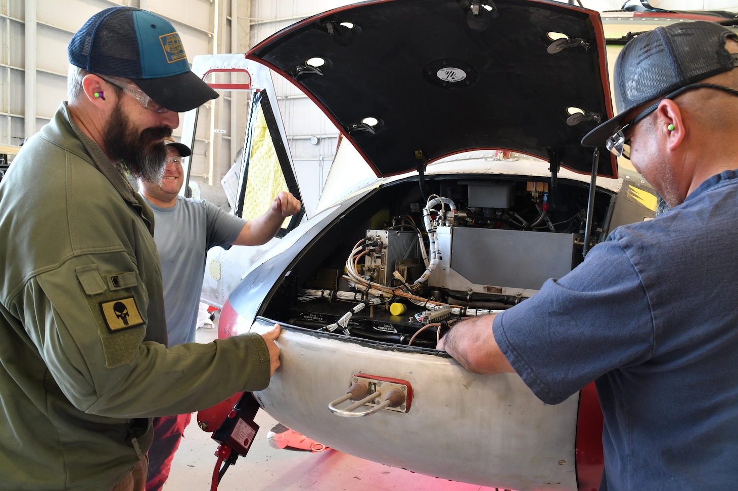 Matthew Pitts, left, the UH-1N deputy branch head and test pilot at Fleet Readiness Center East (FRCE), and Gabriel Rodriguez, a UH-1N plane captain, utilize a battery-powered ground power unit (GPU) while conducting checks on a UH-1N helicopter. FRCE’s UH-1N production line is swapping out diesel-powered GPUs for battery-powered GPUs, becoming the first adapter of this technology within the Naval Aviation community.