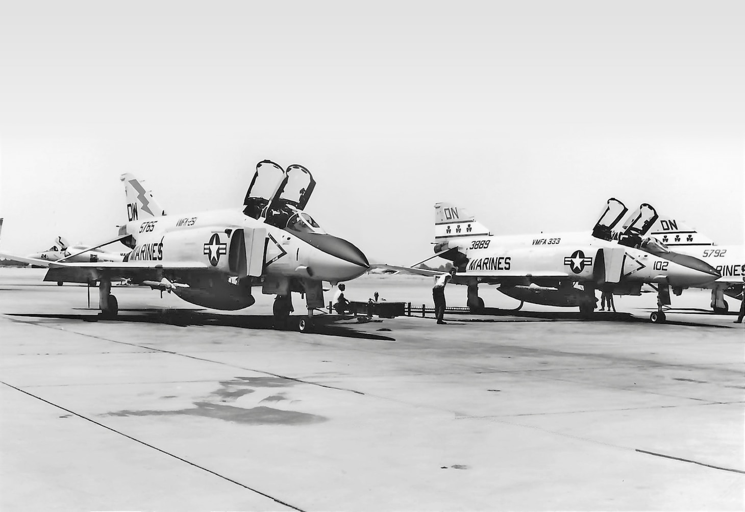 Two squadrons are represented here, perhaps on the VMFA-321 line, at Andrews Air Force Base, Maryland. Left to right, an F-4S of VMFA-251, then two F-4Js from VMFA-333. Note the “thunderbolt” and the three shamrocks, respectively.