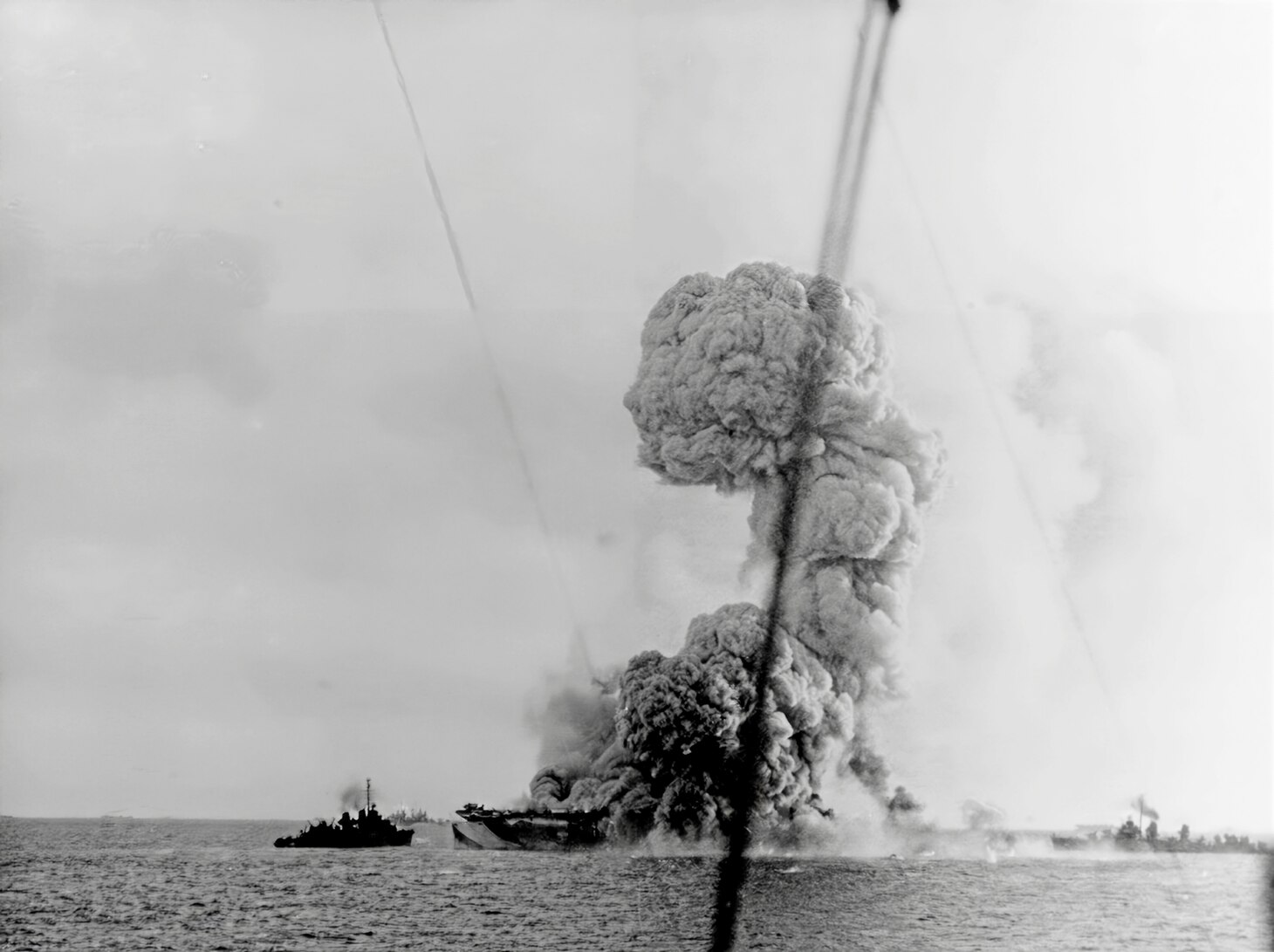 Explosion on board after the ship was attacked by a kamikaze in the Sulu Sea, 4 January 1945. Destroyers are standing by.