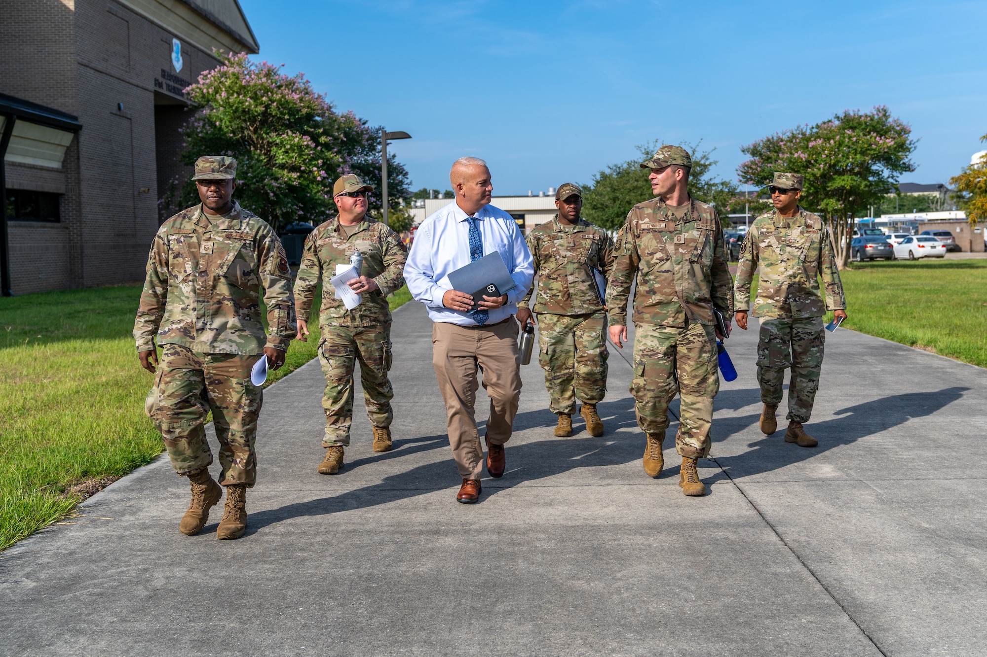 U.S. Air Force Chief Master Sgt. Michael Venning, 81st Training Wing command chief, and Mr. Craig Biddington, 81st TRW director of staff, walk to their next location during an immersion tour with the 81st Training Group at Keesler Air Force Base, Mississippi, Aug. 1, 2023.