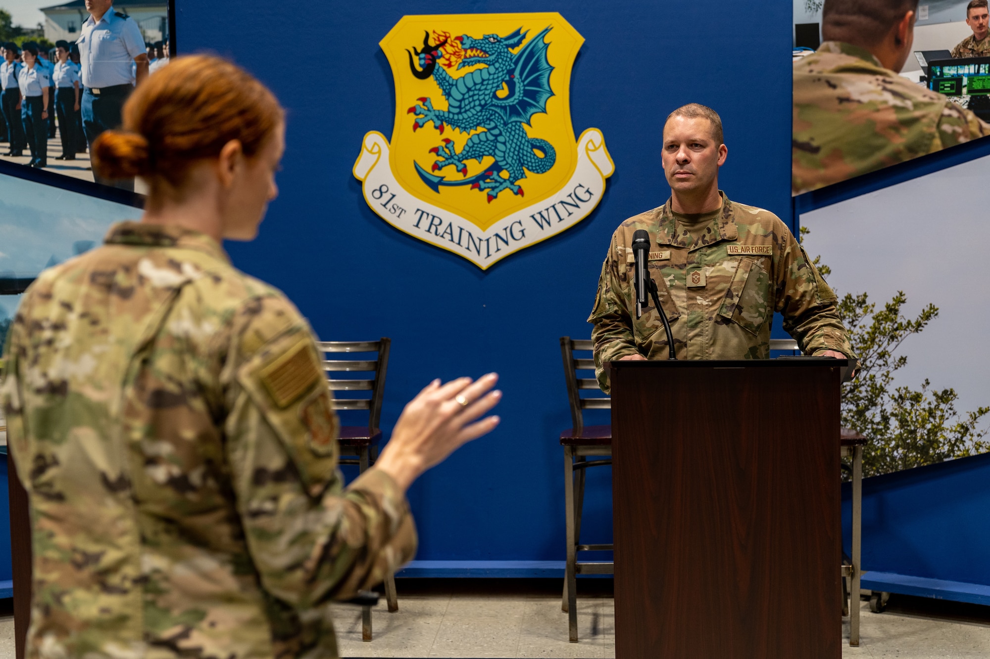 U.S. Air Force Airman 1st Class Elizabeth Davis, 81st Training Wing public affairs specialist, briefs Chief Master Sgt. Michael Venning, 81st Training Wing command chief, during his immersion tour at Keesler Air Force Base, Mississippi, Aug. 11, 2023.