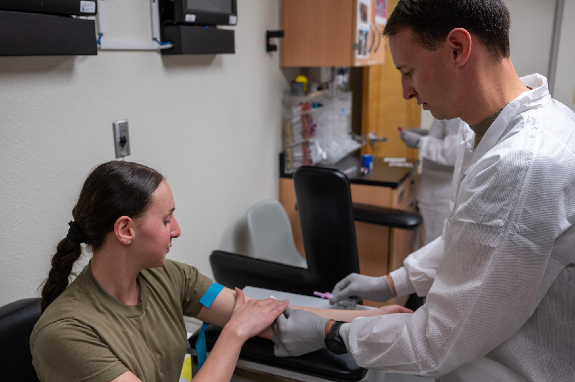 U.S. Air Force Staff Sgt. Chris Babcock, 563 Operational Support Squadron independent medical technician, draws blood from Senior Airman Kristi Shyti, 355th Force Support Squadron food service journeyman, at Davis-Monthan Air Force Base, Ariz., Aug. 17, 2023. Airmen received blood tests to ensure they were in good health. (U.S. Air Force photo by Airman 1st Class Jasmyne Bridgers-Matos)