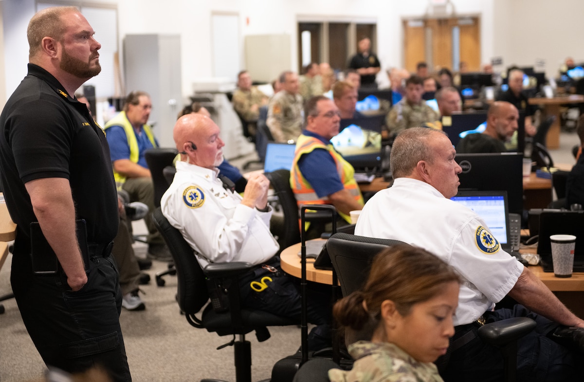 First responders, emergency service and military members sit in a conference.