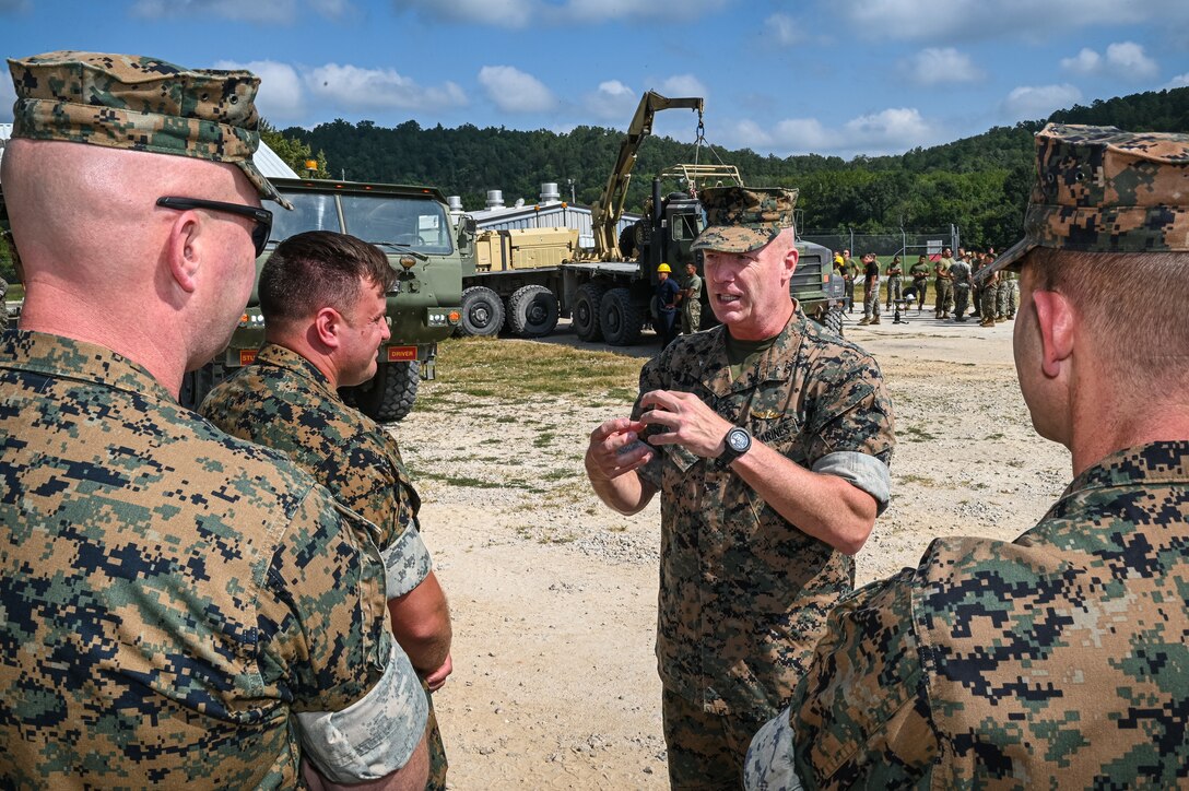 Marine Brig. Gen. Michael McWilliams, 2nd Marine Logistics Group commanding general, talks with Marine Corps Detachment Fort Leonard Wood leadership Wednesday while visiting Training Area 61, where Motor Transport Instruction Company instructors teach the Vehicle Recovery Course.