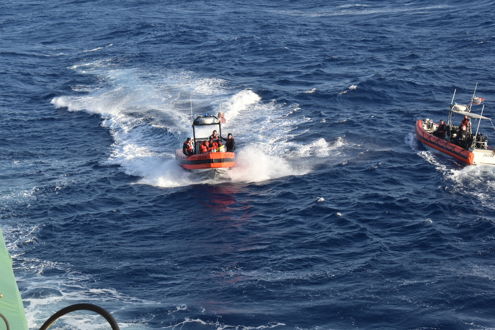 A Coast Guard small boat crew assigned to Coast Guard Cutter Resolute (WMEC 620) transfers Haitian migrants from their unseaworthy vessel to the Resolute off the coast of Haiti, July 15, 2023. Resolute conducted migrant interdiction and deterrence operations in support of Operation Vigilant Sentry. (U.S. Coast Guard photo by Petty Officer 1st Class David Deal)