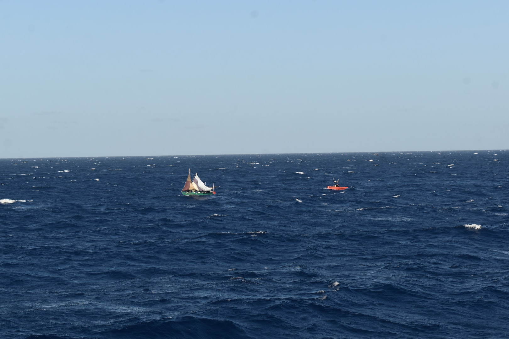 A Coast Guard small boat crew assigned to Coast Guard Cutter Resolute (WMEC 620) interdicts a Haitian migrant vessel with 94 people aboard, 30 miles offshore in the Caribbean Sea, July 15, 2023. Resolute conducted migrant interdiction and deterrence operations in support of Operation Vigilant Sentry. (U.S. Coast Guard photo by Petty Officer 1st Class David Deal)