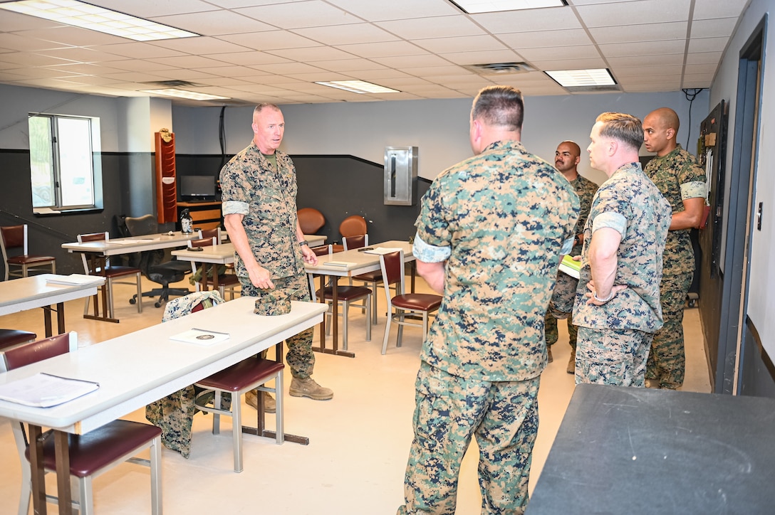 Marine Brig. Gen. Michael McWilliams, 2nd Marine Logistics Group commanding general, talks with Marine Corps Detachment Fort Leonard Wood leadership Wednesday while visiting the classrooms at Training Area 61, where Motor Transport Instruction Company instructors teach the Vehicle Recovery Course.