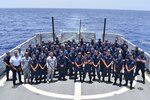 Coast Guardsman assigned to the U.S. Coast Guard Cutter Resolute (WMEC 620) attend a quarters meeting on the flight deck during a patrol in the Windward Passage supporting Operation Vigilant Sentry, July 1, 2023. At quarters, the Resolute introduced newly reported crew members and promoted the unit's Executive Officer, Cmdr. Mario Gil, to the rank of Commander. (U.S. Coast Guard photo by Petty Officer 1st Class David Deal)