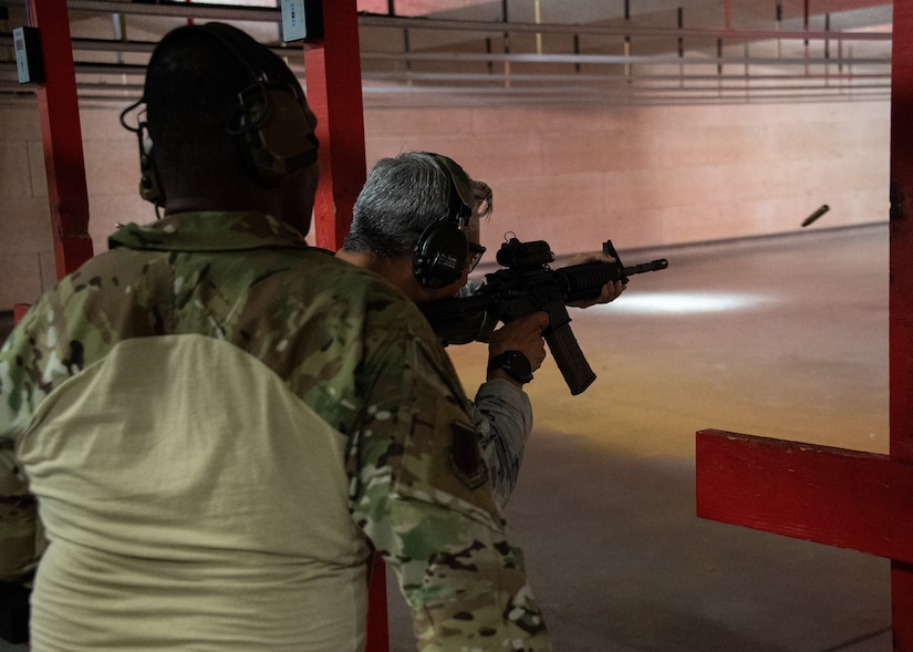 A person shoots a gun at a range.