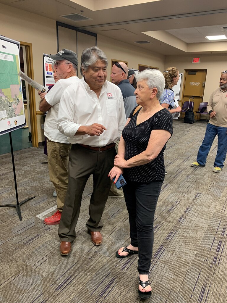 Los Angeles District environmental lead and Formerly Used Defense Site program manager Harry Hendler, pictured in white, answers questions for Clark County residents during a public meeting discussing the Nellis Remedial Action FUDS Project July 25 at the Aliante Library in Las Vegas.
