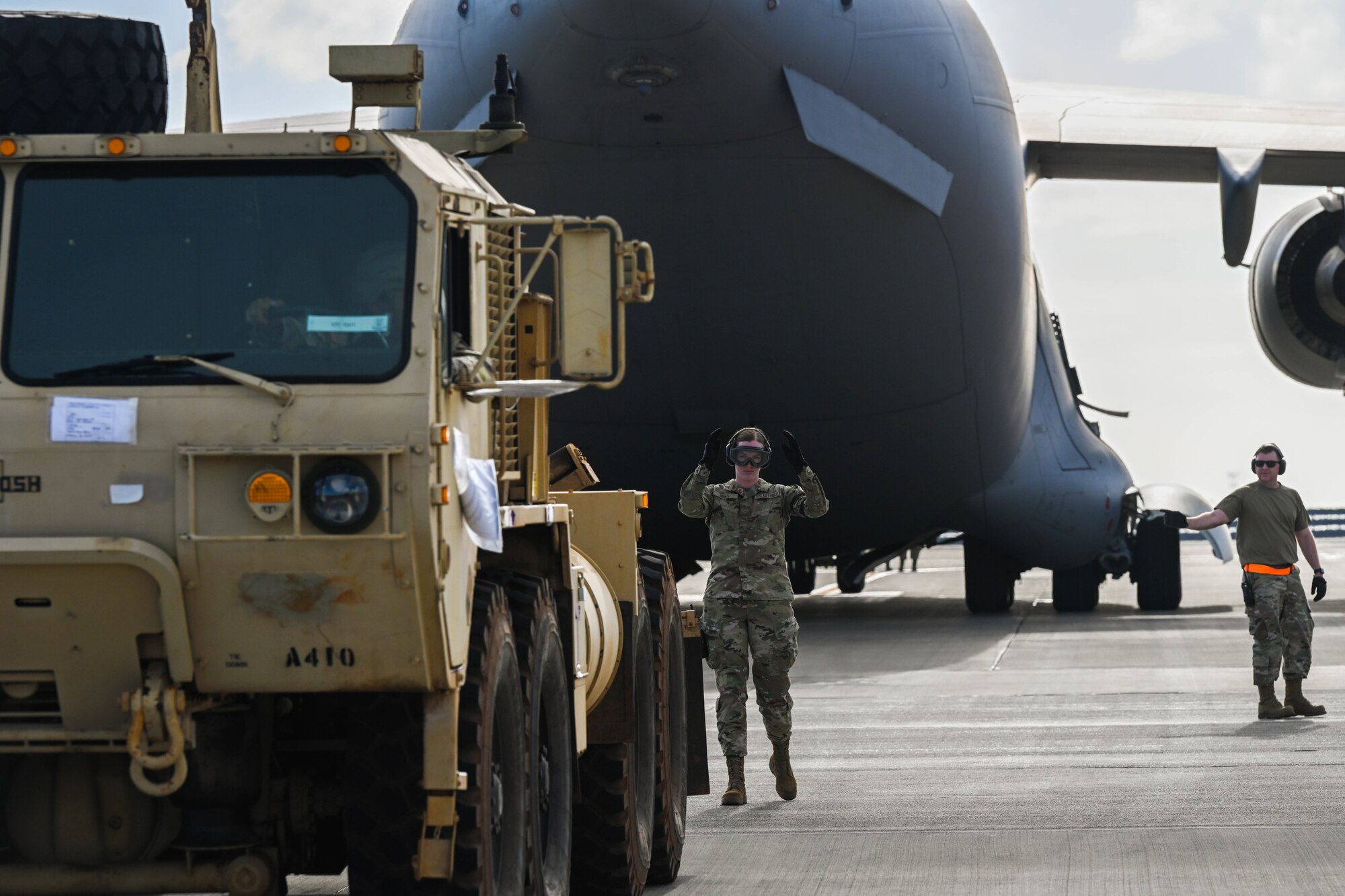 U.S. Army Soldiers drive two Oshkosh Palletized Load Systems onto a C-17 Globemaster III in support of the Maui wildfire recovery efforts at Joint Base Pearl Harbor-Hickam, Hawaii, August 27, 2023. Airmen and Soldiers from the 535th AS and 225th Brigade Support Battalion delivered equipment and resources to Joint Task Force-50 to help the communities affected by the wildfires in Maui. (U.S. Air Force photo by Senior Airman Makensie Cooper)