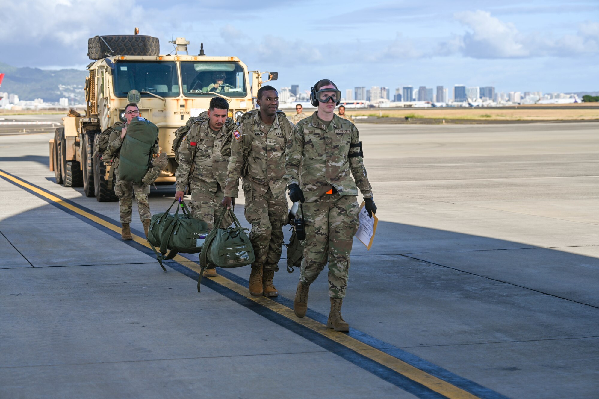 U.S. Army Soldiers assigned to the 225th Brigade Support Battalion to secure an Oshkosh Palletized Load System on a C-17 Globemaster III during a humanitarian aid and disaster relief flight in support of the Maui wildfire recovery efforts at Joint Base Pearl Harbor-Hickam, Hawaii, August 27, 2023. Members from the 535th Airlift Squadron, worked alongside members from the 735th Air Mobility Squadron and Soldiers assigned to the 225th Brigade Support Battalion to support Joint Task Force-50 in Maui to provide relief and supplies to those affected by the wildfires. (U.S. Air Force photo by Senior Airman Makensie Cooper)