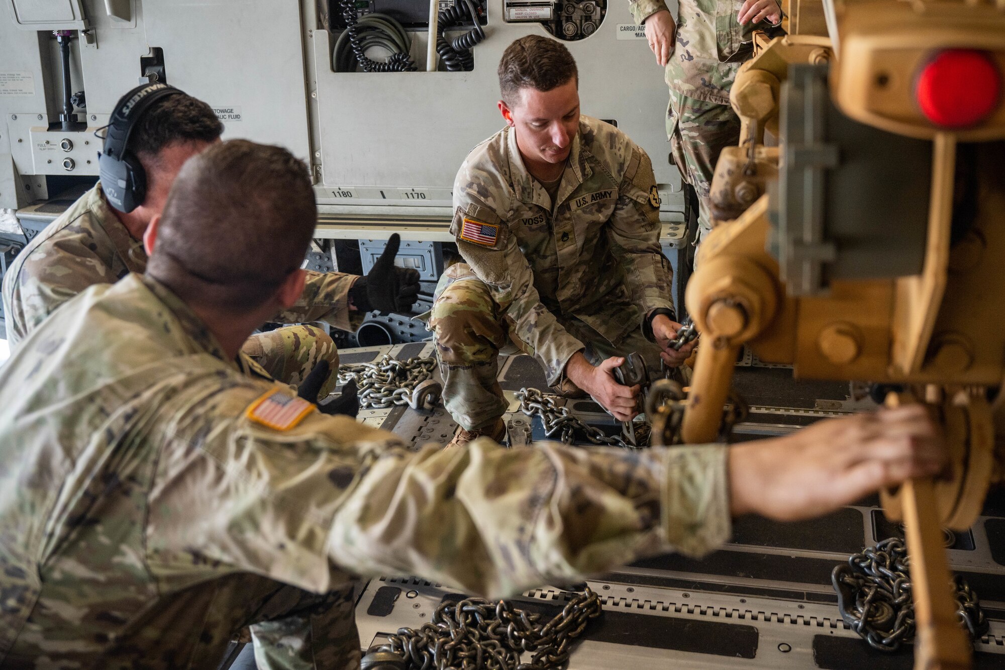 U.S. Army Soldiers assigned to the 225th Brigade Support Battalion to secure an Oshkosh Palletized Load System on a C-17 Globemaster III during a humanitarian aid and disaster relief flight in support of the Maui wildfire recovery efforts at Joint Base Pearl Harbor-Hickam, Hawaii, August 27, 2023. Members from the 535th Airlift Squadron, worked alongside members from the 735th Air Mobility Squadron and Soldiers assigned to the 225th Brigade Support Battalion to support Joint Task Force-50 in Maui to provide relief and supplies to those affected by the wildfires. (U.S. Air Force photo by Senior Airman Makensie Cooper)