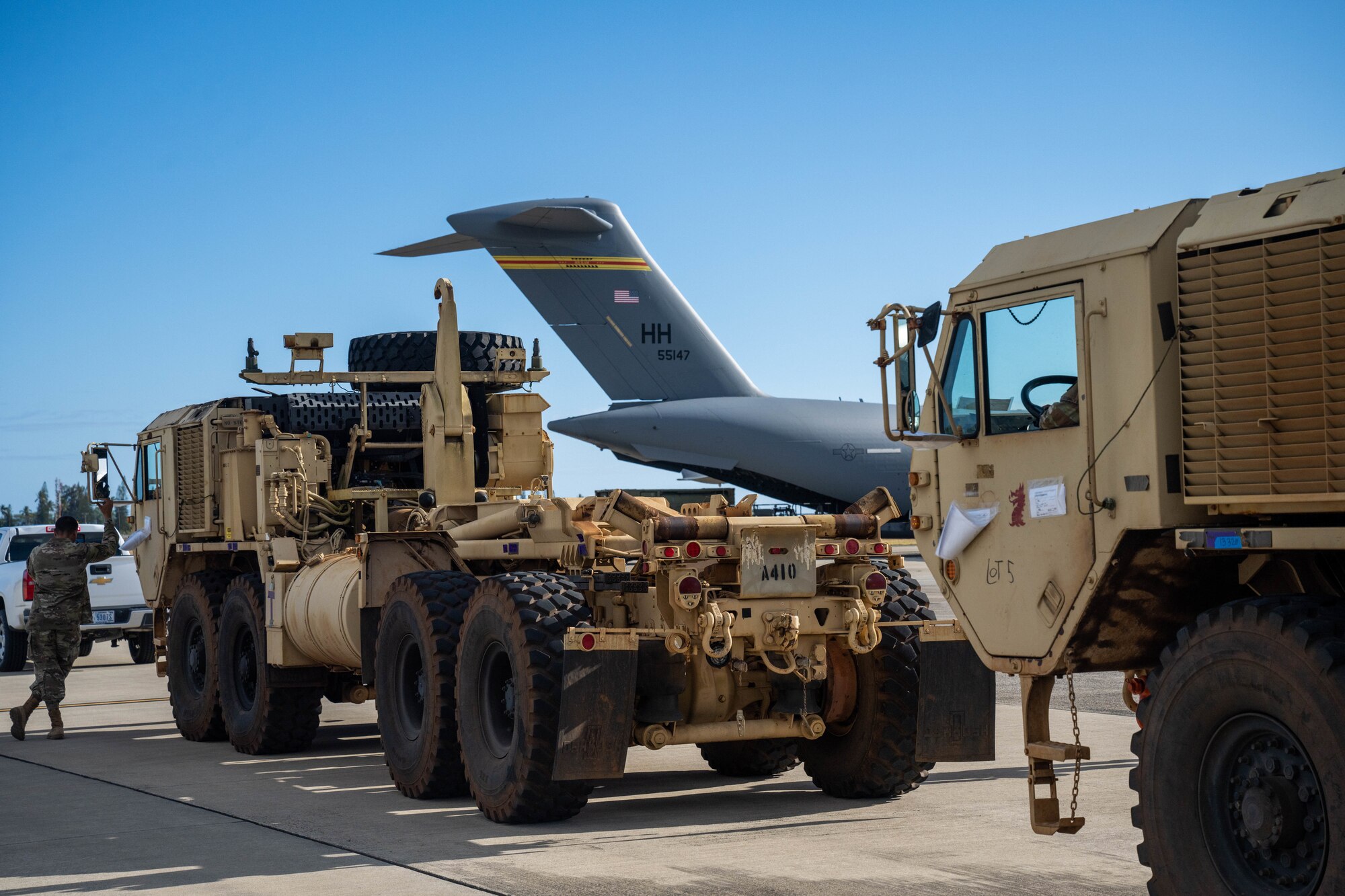 U.S. Army Soldiers assigned to the 225th Brigade Support Battalion load two Oshkosh Palletized Load Systems onto a C-17 Globemaster III in support of the Maui wildfire recovery efforts at Joint Base Pearl Harbor-Hickam, Hawaii, August 27, 2023. Members from the 535th Airlift Squadron, worked alongside members from the 735th Air Mobility Squadron and Soldiers assigned to the 225th Brigade Support Battalion to support Joint Task Force 50 in Maui to provide relief and supplies to those affected by the wildfires. (U.S. Air Force photo by Senior Airman Makensie Cooper)