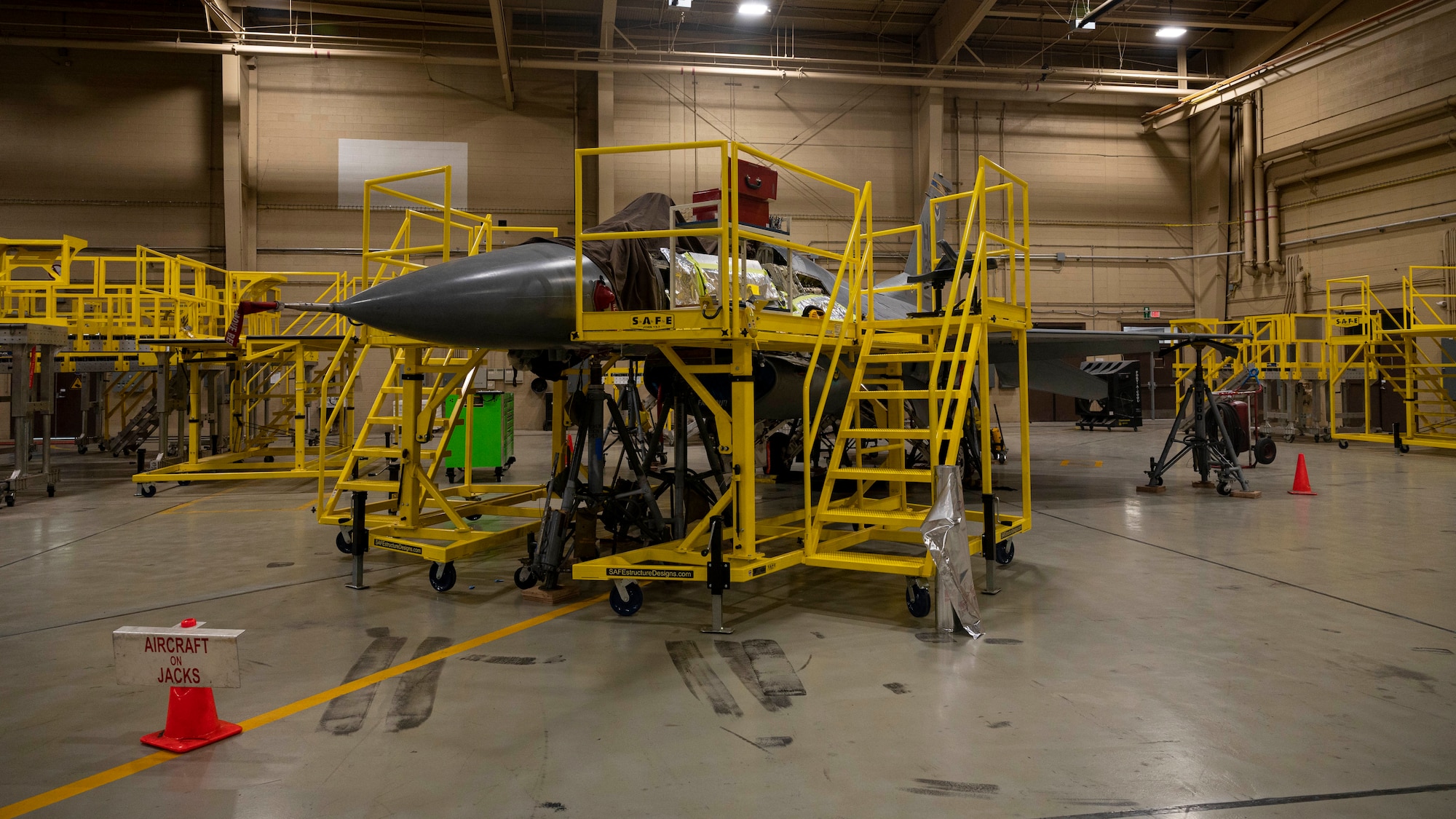 An F-16 Viper assigned to the 311th Fighter Squadron awaits repairs in a hangar at Holloman Air Force Base, New Mexico, July 27, 2023.