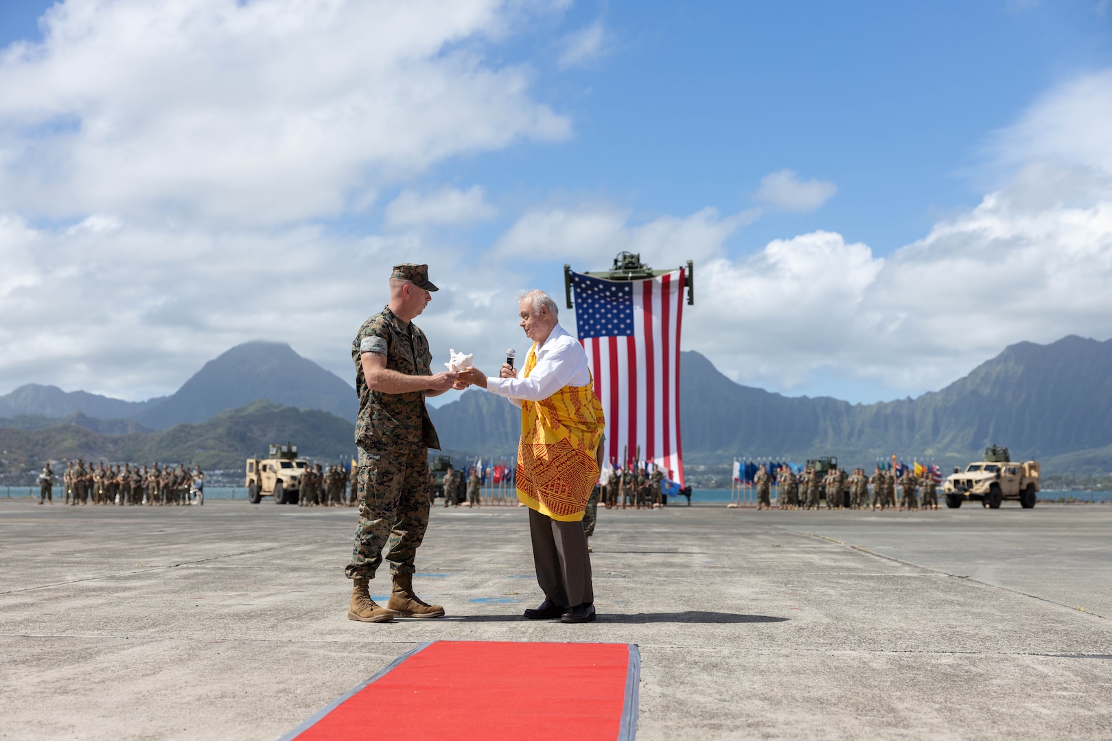 U.S. Marine Corps Lt. Col. Heath Phillips, commanding officer, 1st Low Altitude Air Defense (LAAD) Battalion, Marine Air Control Group 18, 1st Marine Aircraft Wing, receives a gift during a reactivation and designation ceremony at Marine Corps Air Station Kaneohe Bay, Hawaii, Aug. 31, 2023. Originally activated in July 1982 in Okinawa, Japan, the unit underwent two redesignations before folding its’ colors in Sept. 2007. The reactivation of 1st LAAD Battalion demonstrates forward progression toward force modernization in the INDOPACIFIC region. The primary mission of 1st LAAD Battalion is to deliver close-in, low-altitude, surface-to-air weapon capabilities. (U.S. Marine Corps photo by Lance Cpl. Clayton Baker)