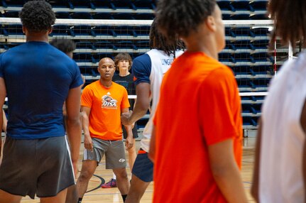 Darden looking at players on a basketball court