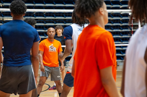 Darden looking at players on a basketball court