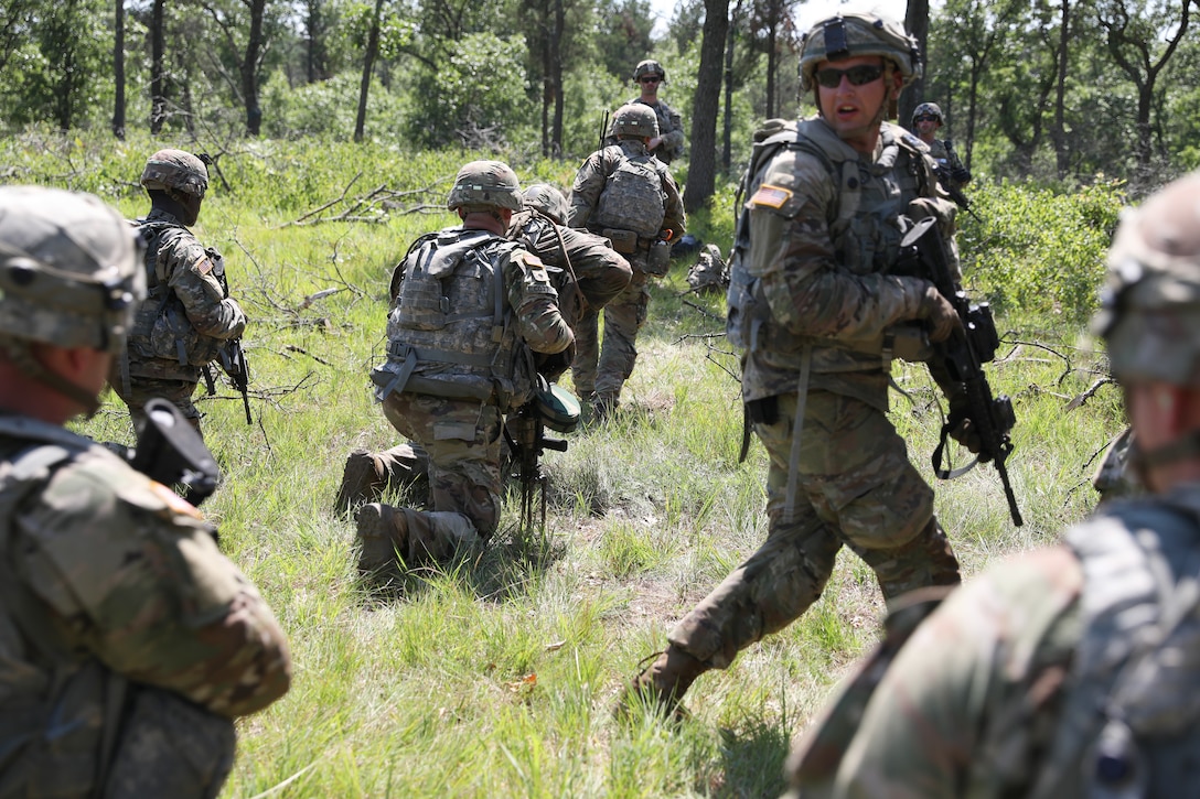 Wisconsin National Guard Soldiers from the 2nd Battalion, 127th Infantry Regiment, and the 173rd Brigade Engineer Battalion, 32nd Infantry Brigade Combat Team, coordinate on a live-fire exercise featuring squad movements, reacting to simulated enemy contact and the use of a Bangalore torpedo explosive charge during eXportable Combat Training Center training July 27, 2023, at Fort McCoy, Wis.