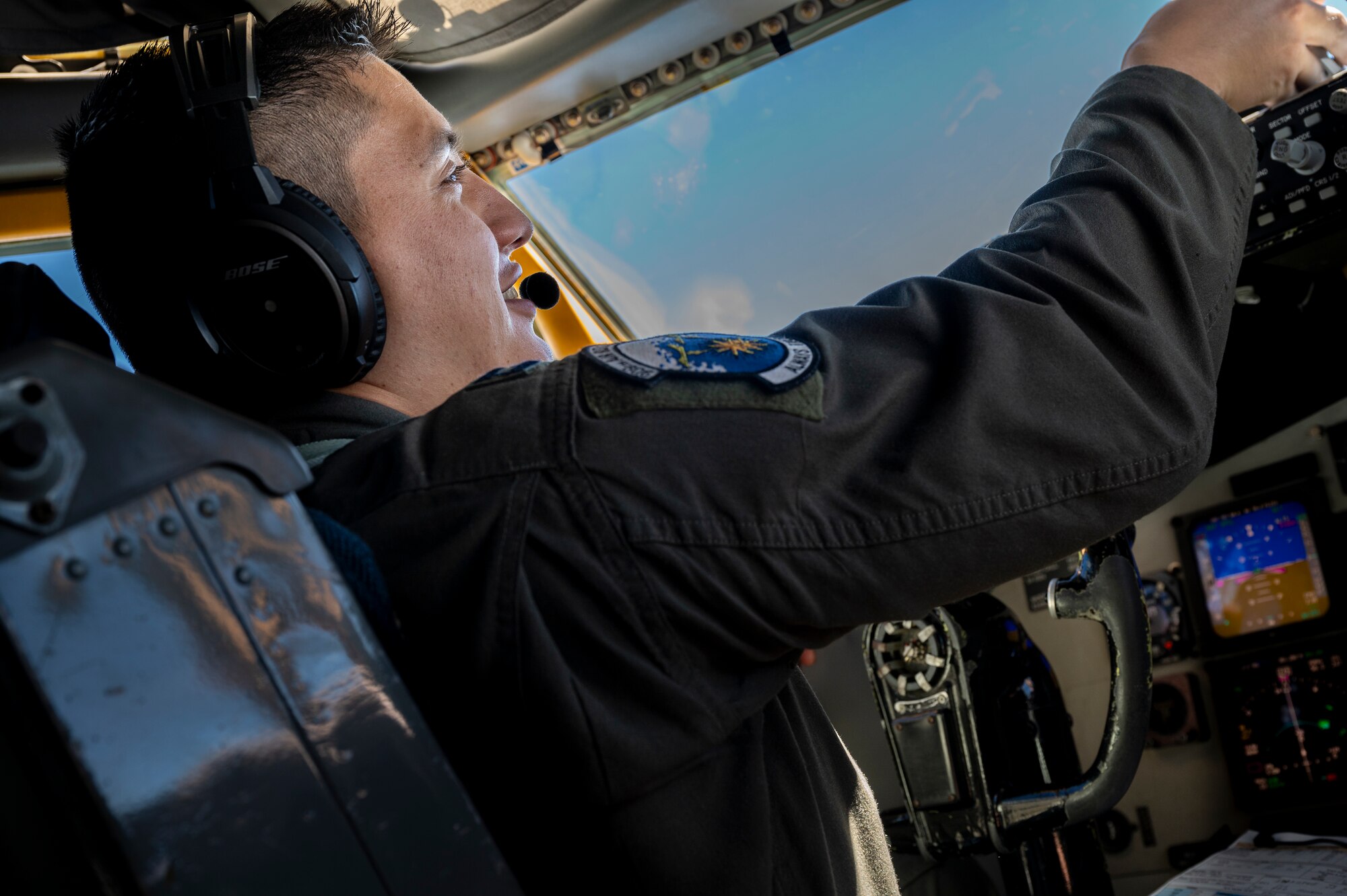 U.S. Air Force Capt. Andrew Sanchez, 909th Air Refueling Squadron pilot, makes flight adjustments to a KC-135 Stratotanker during an aerial refueling mission over the Sea of Japan, Aug. 30, 2023.