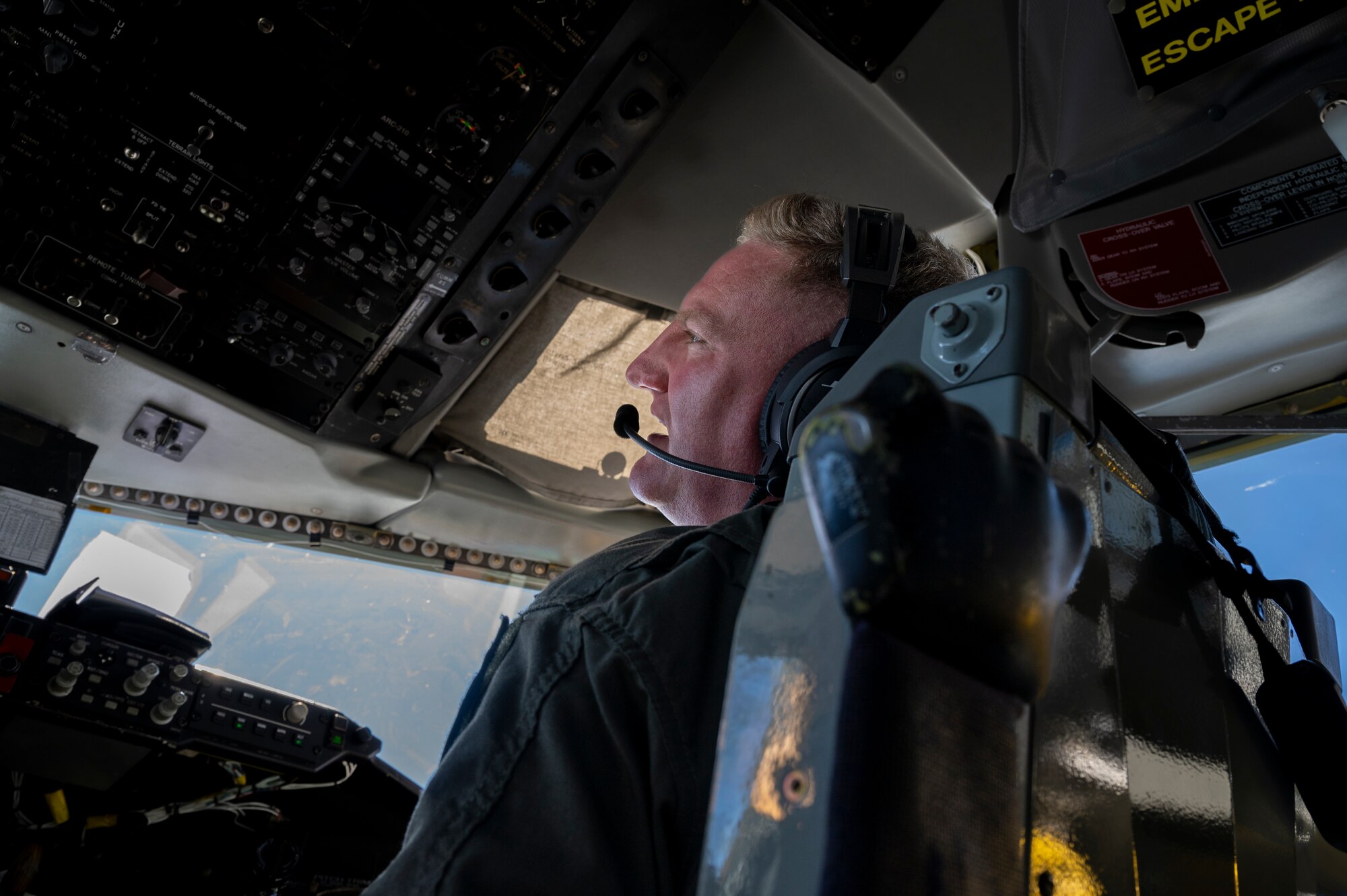 U.S. Air Force Lt. Col. Travis Epp, 909th Air Refueling Squadron pilot, communicates to boom operators during an aerial refueling mission in a KC-135 Stratotanker over the Sea of Japan, August 30, 2023.