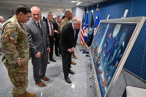 Secretary of the Air Force Frank Kendall, right, examines a painting by artist Warren Neary, second from left, after an unveiling ceremony at the Pentagon, Arlington, Va., Aug. 29, 2023. The painting celebrates the 75th anniversary of the U.S. Air Force. (U.S. Air Force photo by Eric Dietrich)